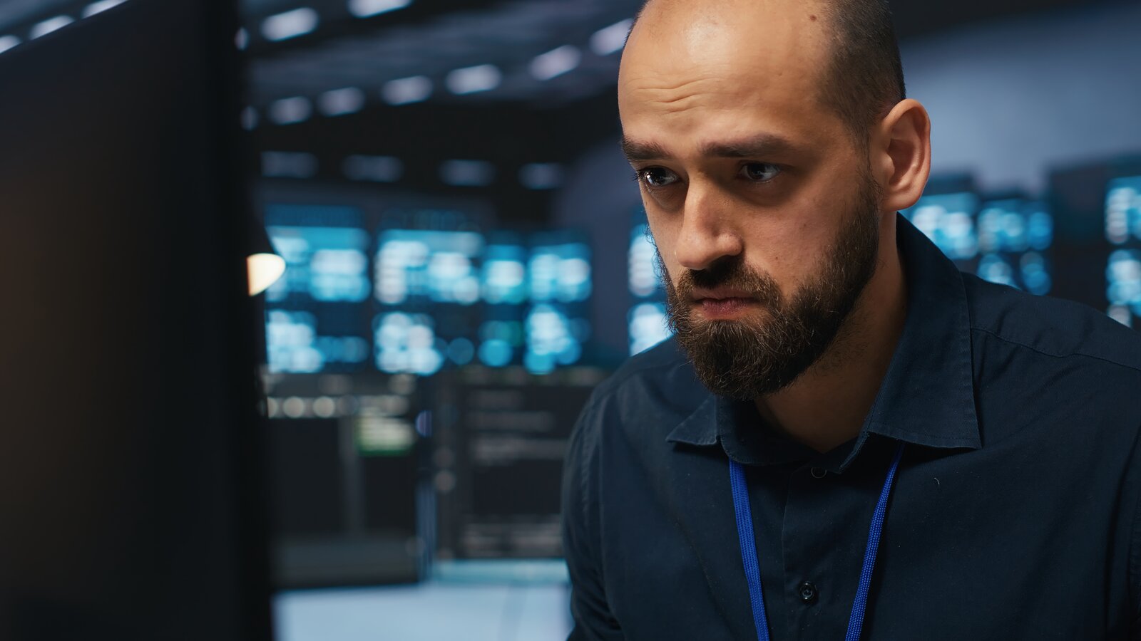 Overworked engineer handling every task alone in a data centre
