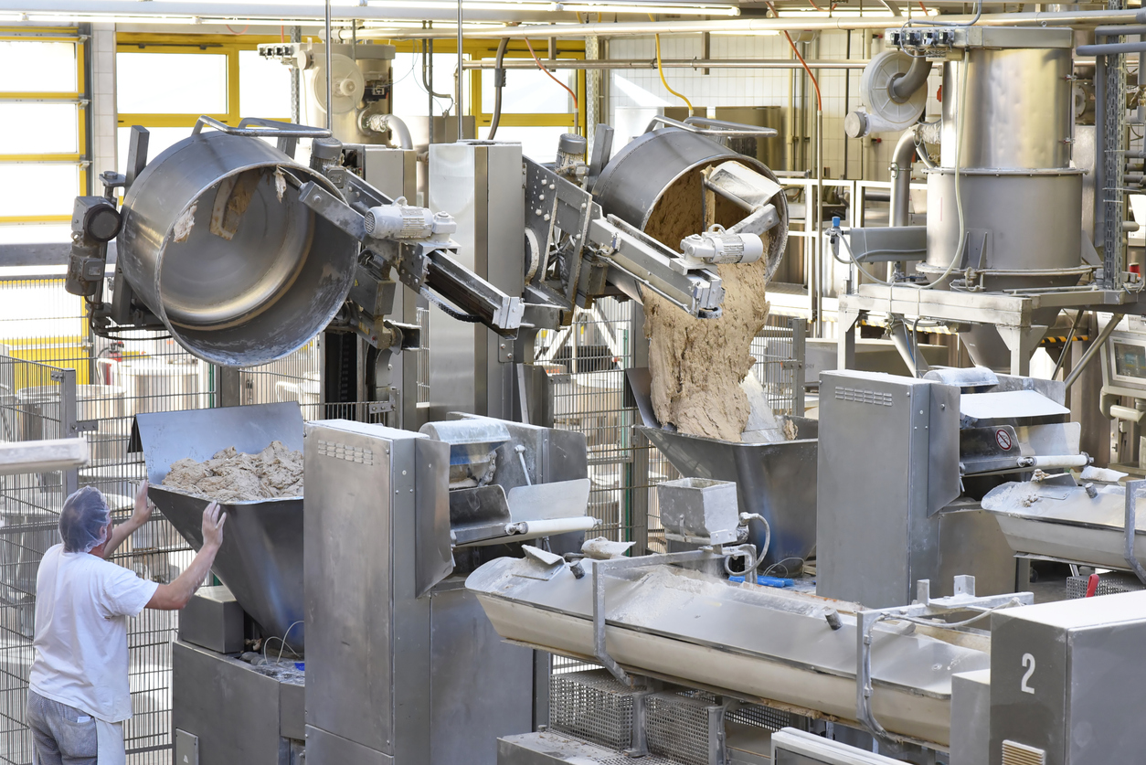 Food processing facility with staff tending to machines | CMMS