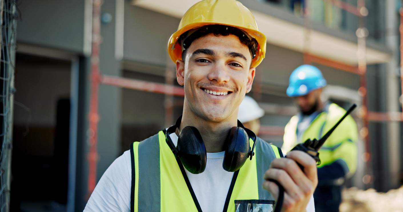 Maintenance worker in safety vest and radio in hand | Maintenance Teams