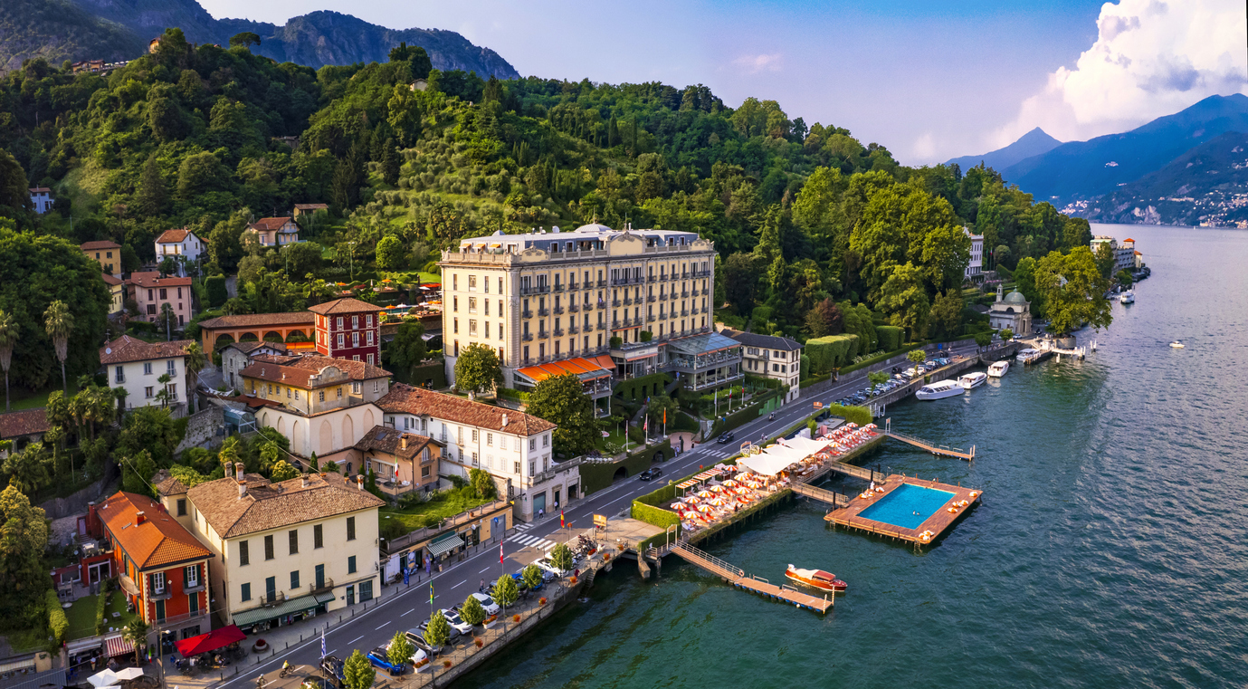 Boutique hotel sits on a beautiful lake with a blue swimming pool