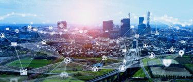 Aerial view of a city with overlay of connections to assets indicating iOT