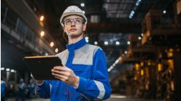 CMMS for Manufacturing user with tablet on factory floor