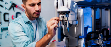 Technician in lab works on machine while performing preventive maintenance