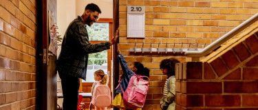 CMMS | child gives teacher high five when entering classroom