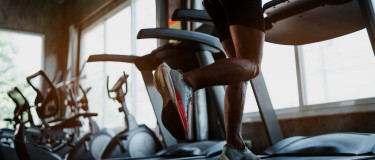 Runner works out on treadmill in hotel gym | CMMS