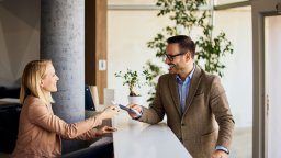 Hotel reception greets hotel guest | Maintenance Management