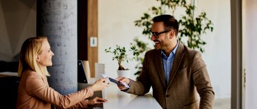 Hotel reception greets hotel guest | Maintenance Management