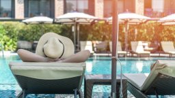 Hotel pool maintenance guest lays on chair | CMMS