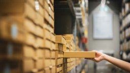 Arm and hand of person reaching out to restock inventory on shelf | CMMS