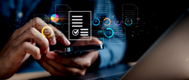 Hand holding phone with CMMS-related icons hovering above it | Maintainly