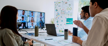 Remote workers on screen next to graphs | Maintainly