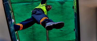 Maintenance worker steps between platforms while inspecting assets | Fixd Asset