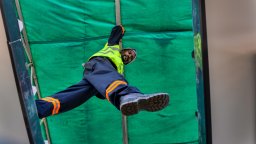 Maintenance worker steps between platforms while inspecting assets | Fixd Asset