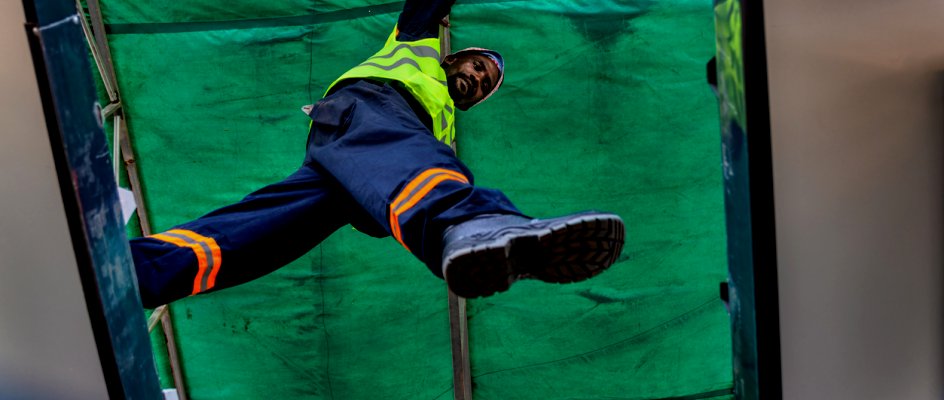 Maintenance worker steps between platforms while inspecting assets | Fixd Asset