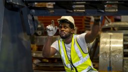 CMMS | Maintenance worker performs work underneath heavy equipment