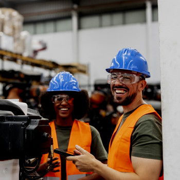 Two maintenance workers with mobile device looking at camera