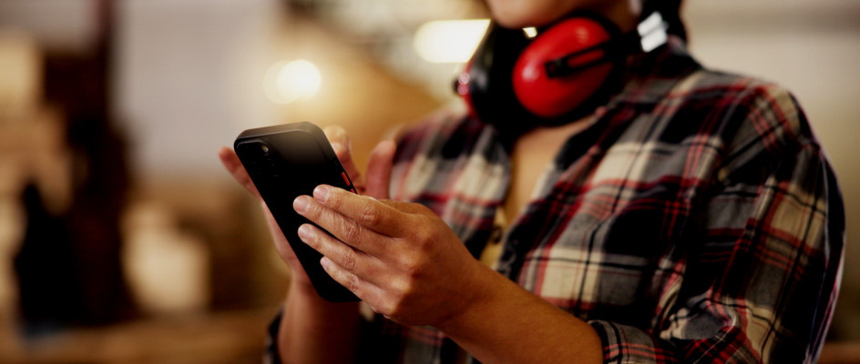 Maintenance worker completes work order on mobile phone CMMS app