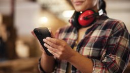 Maintenance worker completes work order on mobile phone CMMS app