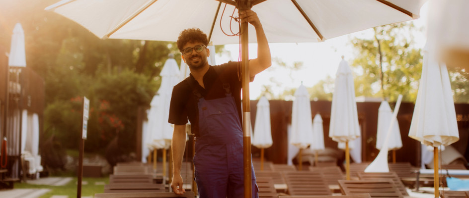 Resort maintenance worker fixes umbrella near pool | CMMS