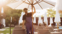Resort maintenance worker fixes umbrella near pool | CMMS