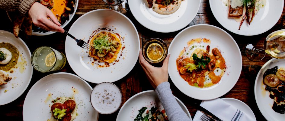 Plates of restaurant food with hands and arms | Maintenance