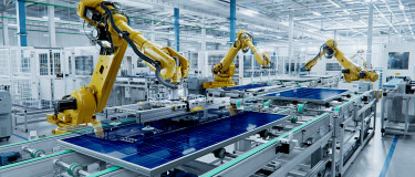 Solar panels on factory floor with manufacturing robots | CMMS