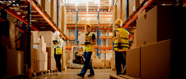 CMMS | Inventory management workers move stock in warehouse