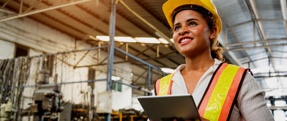 Female maintenance worker stands in front machines | CMMS